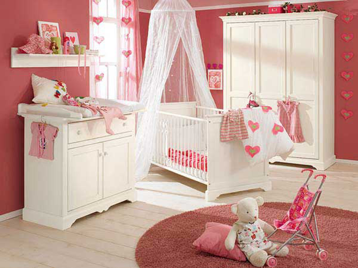 Amazing White Set Baby Bedroom Design Furniture With Pink Wall PaintWhite CurtainLong WindowPictureAccessoriesPillowSimple Baby Nursery Chest Of Drawer White WardrobeFur RugClothes And White Stained Floor Bedroom