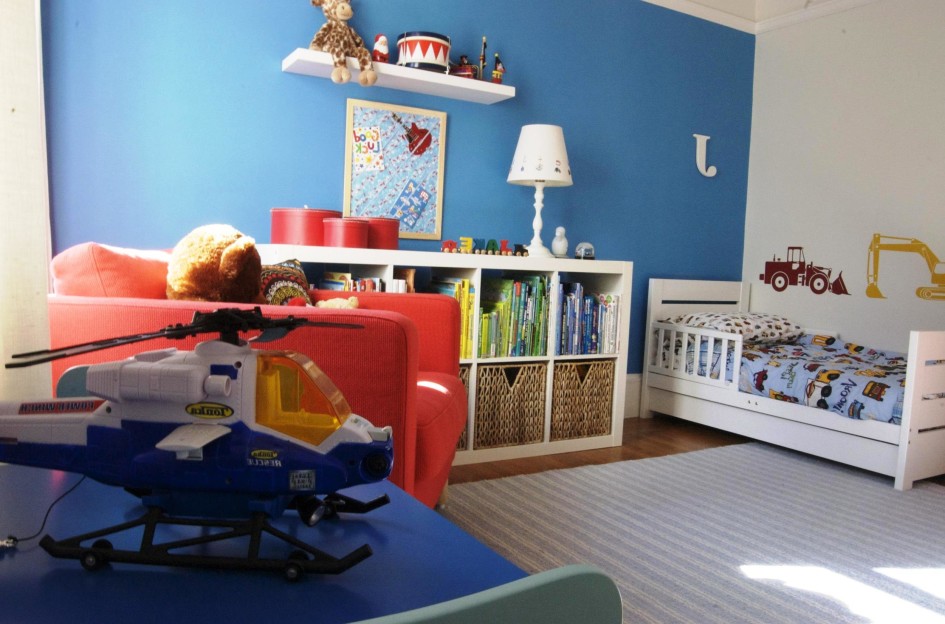Blue Toddler Bedroom Ideas And Carpet Flooring Design And White Wall Shelf And Laminate Flooring With Minimalist Book Storage Design With Red Armchair And Toys Decorating And Blue Wall Decoration Ideas