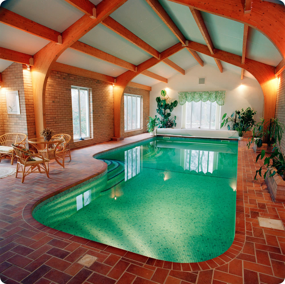 Lovely Indoor Swimming Pool Design Ideas With Wooden Ceiling Pure Water Stained Flooring Window Lighting Sitting Space Several Plants And Amazing Wall Design Pool Design