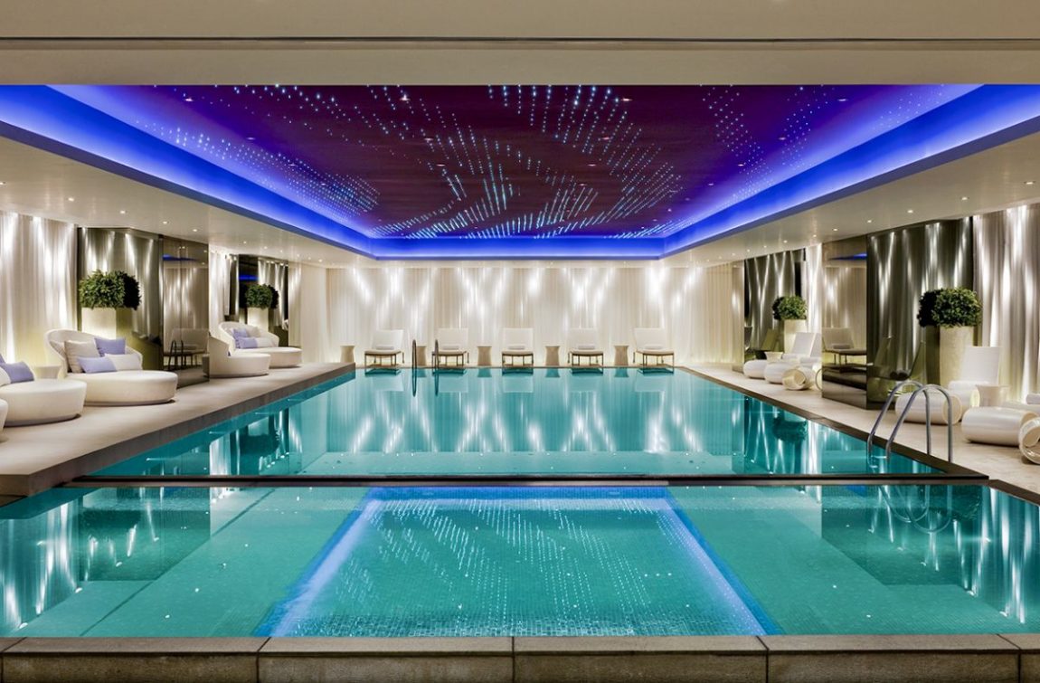 Pool Design Large-size Luxury Indoor Swimming Pool Design Interior With Pure Water Modern White Comfy Beach Awesome Lighting Several Plant Accessories Sitting Space And Amazing Ceiling Ideas Pool Design