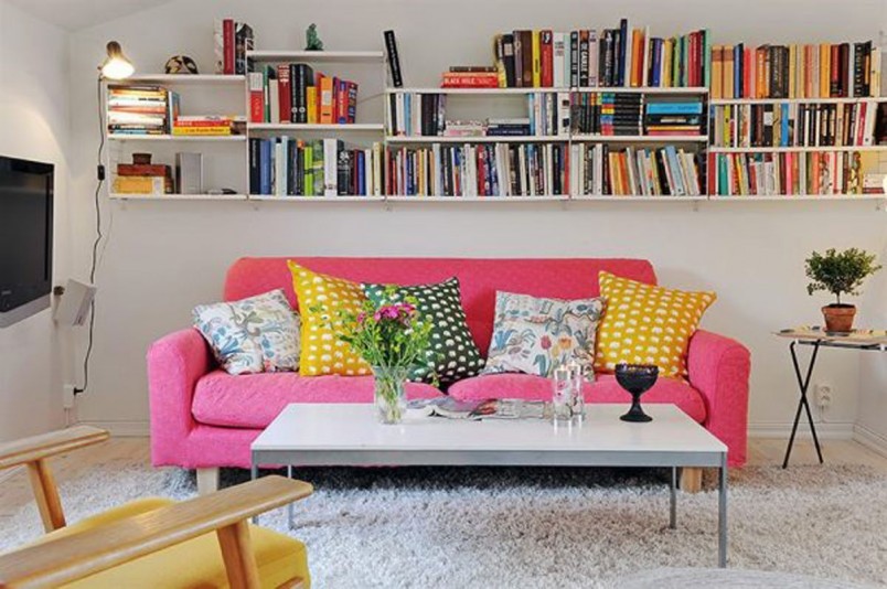 Furniture + Accessories Large-size Apartment Interior Eye Catching Colorful Cushion As Well As Pink Sofa Idea In White Apartment Nuance Escorted By Bookshelves As Well As Table On White Fur Rug Also Wood Chair Furniture + Accessories