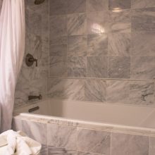Bathroom Thumbnail size Enjoyable Gray Marble Subway Tile Wall Panelling Bath Escorted By White Rectangular Bathtub As Well As Burnished Bronze Wall Mount Shower Tub Combo Faucet As Well As White Shower Curtain In Vintage