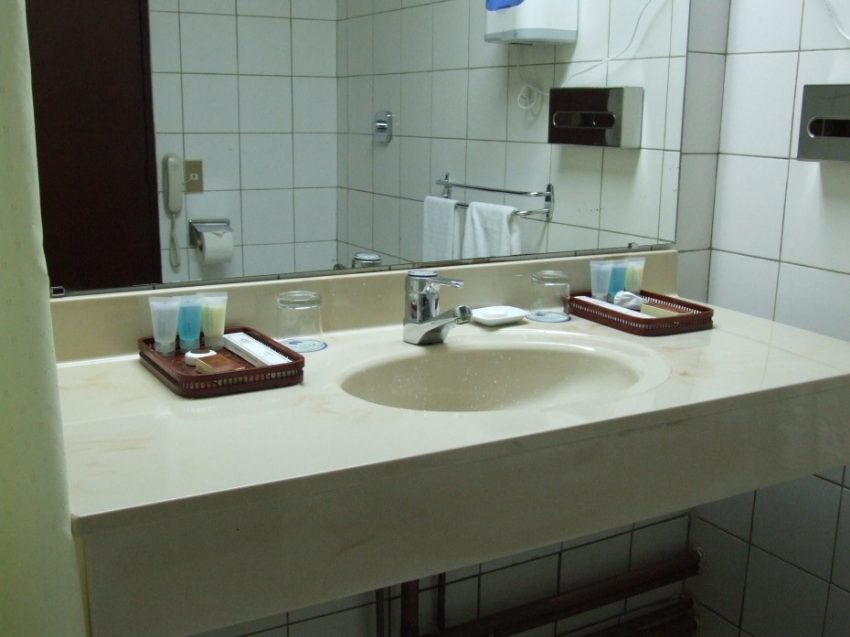 Bathroom Medium size Single Bowl Sink At White Concrete Top Floating Vanities Large Mirror Attach At White Ceramic Wall Panels In Cheap Hotel Bathroom Schemes Soothing Hotel Bathroom