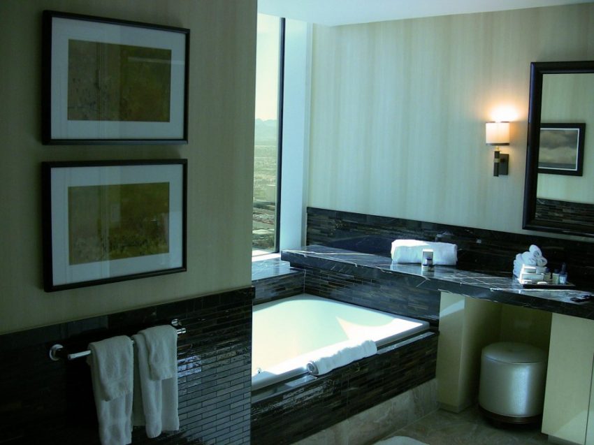 Bathroom Medium size White Acrylic Tub Escorted By Black Granite Top Wall Panels Feat Gray Wall Decals In Modern Hotel Bathroom Schemes Soothing Hotel Bathroom Scheme Furniture As Well As Picture