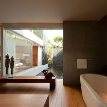 Villa & Resort Thumbnail size Awesome Bathroom Design With Long Oval White Bathtub Before Wooden Bench Splashed With Large Glassy Window
