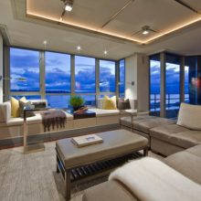 Villa & Resort Thumbnail size Coastal Living Room Design With Luxurious Grey Sofa And Window Reading Nook Swept With Modern Lighting