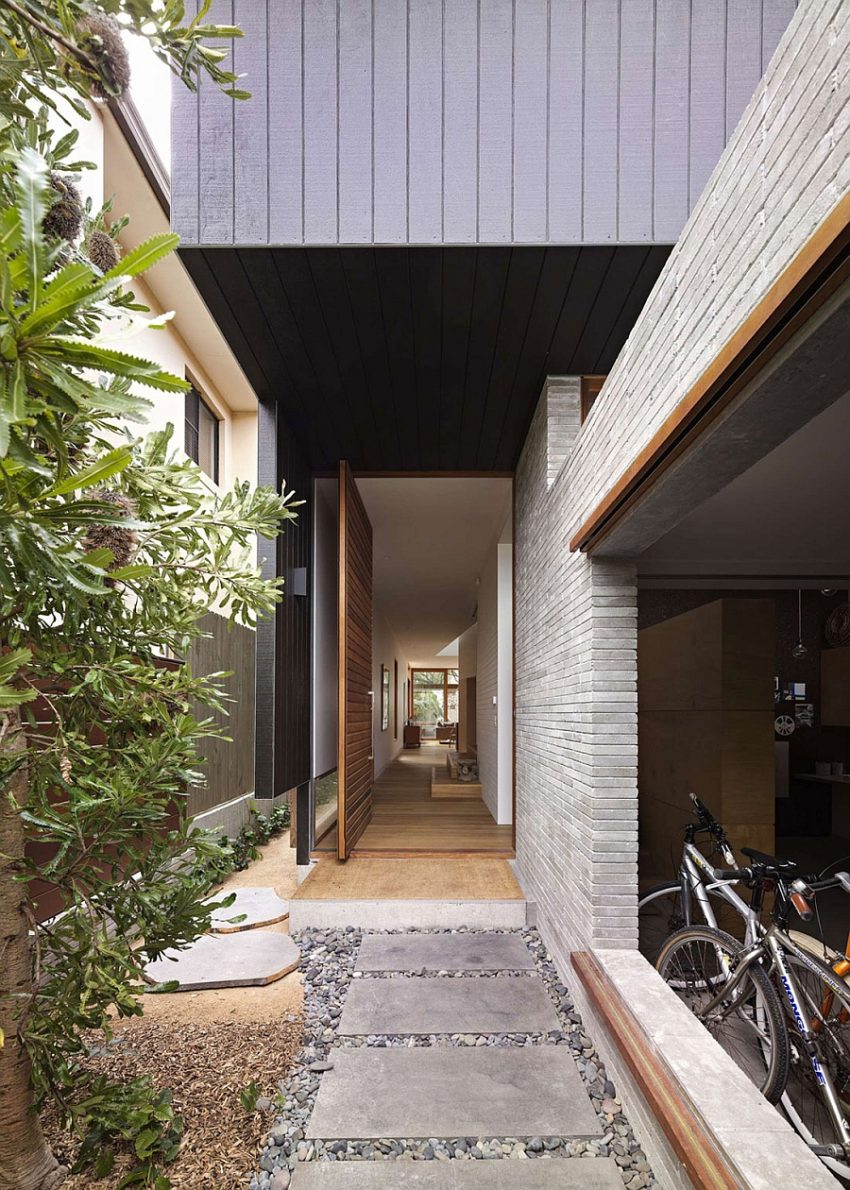 Ideas Concrete Stone Pathway Leading Entryway With Tree Beneath Grey Ceiling Idea Aside Open Bicycle Room Family House with a Lot of Ventilations but Still Maintaining Privacy