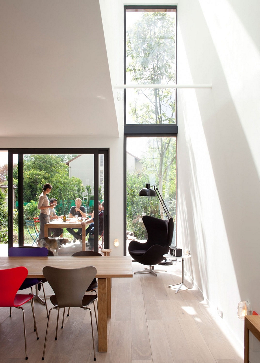 Corner Black Egg Chair Design Beneath Floor To Ceiling Glassy Window Design Facing Colorful Table Set Interior Design
