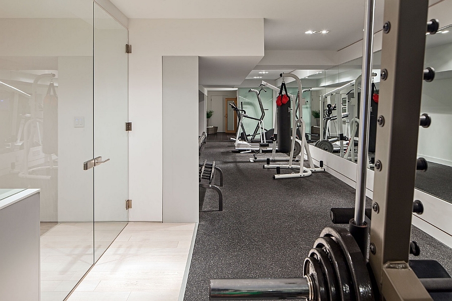 Fully Equipped Fitness Center With Treadmill Upon Grey Area Rug Bordered With Glassy Enclosure Architecture