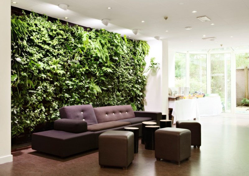 Indoor Wall Garden With Luxurious Tufted Grey Sofa And Evening Hue Leather Ottoman Facing Unique Coffee Table Interior Design