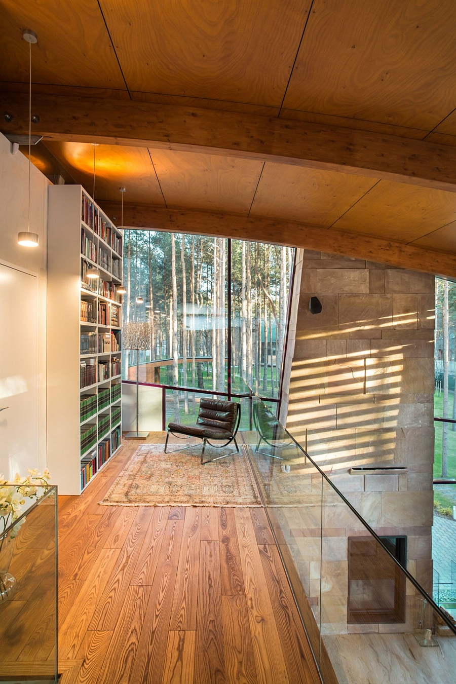 Long Narrow Loft Hallway With Corner Large Bookshelves Facing Comfortable Reclining Chair Beneath Glassy Window Architecture