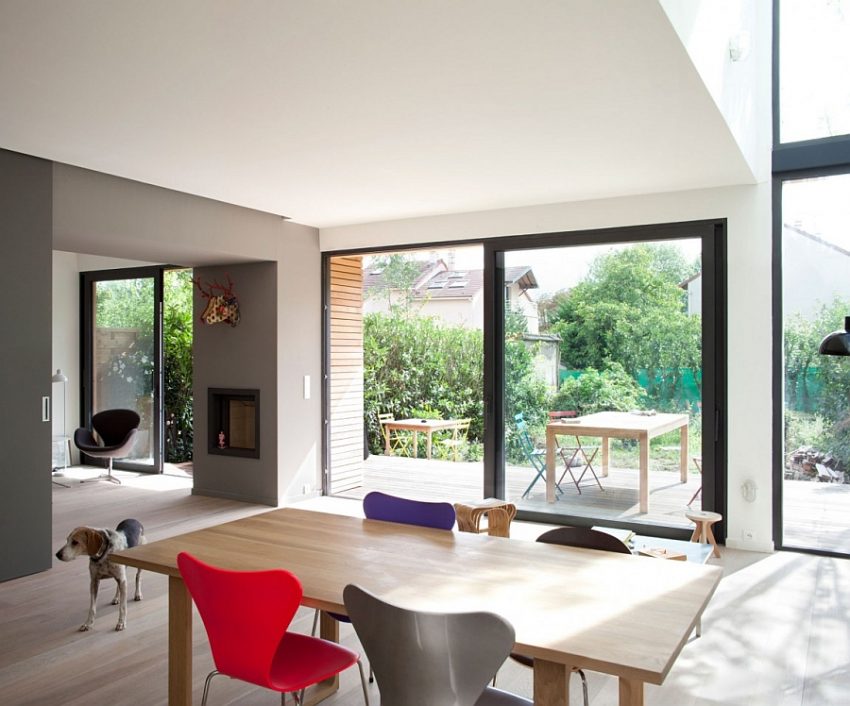 Interior Design Lovely Dining Table With Wooden Countertop And Grey Purple Red Chairs Facing Outdoor View Amazing Eco Friendly Prefabricated Modular House in Paris