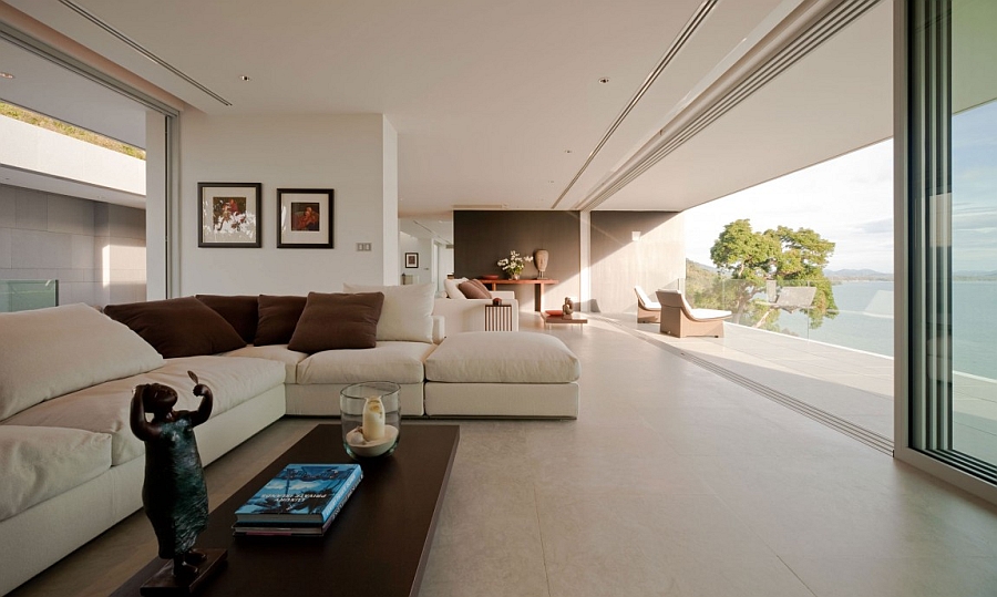 Luxurious Cream Open Living Space With Posh Sectional Sofa Facing Wooden Coffee Table With Photo Gallery Villa & Resort