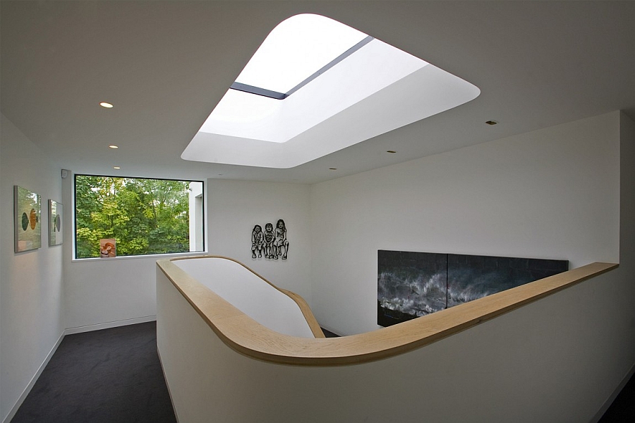Luxurious Urban Skylight Above Spiral Staircase Featuring Recessed Lighting Above Black Floor Interior Design