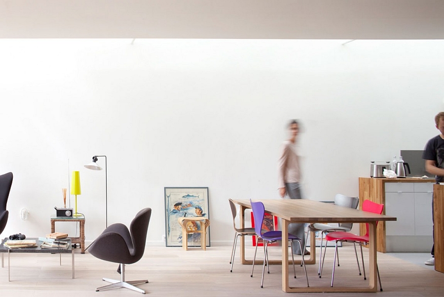 Modern Family Outing Spot With Wooden Table And Purple Red Chairs Facing Bold Black Stool Interior Design