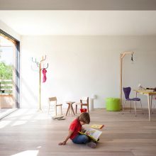 Interior Design Mesmerizing Black Relaxing Chair Aside Floor Lamp Upon Wooden Floor Below Framed Large Window Design Amazing Eco Friendly Prefabricated Modular House in Paris