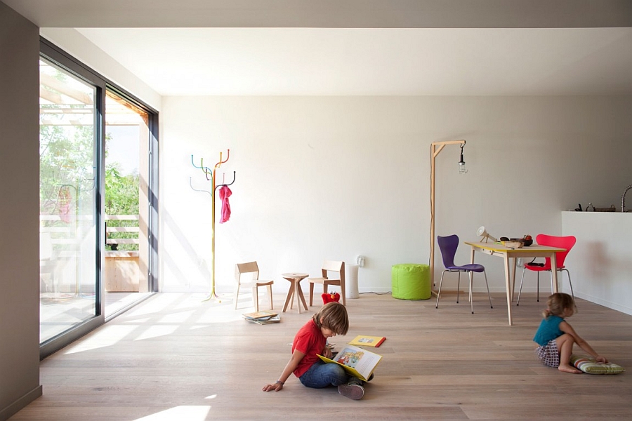 Open Spacious Kids Playroom With Cute Mini Wooden Chairs And Adult Red Blue Social Hub Upon Modern Wooden Floor Interior Design