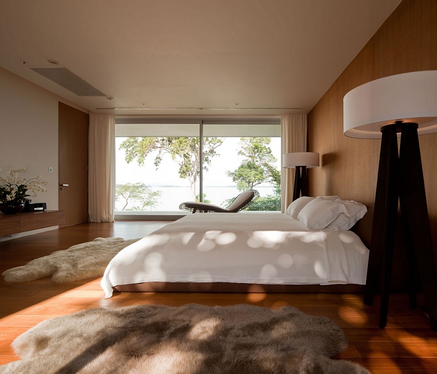 Open White Bedroom Design Upon Wooden Floor With Grey Furry Rug Flashed Generous Glassy Window Villa & Resort