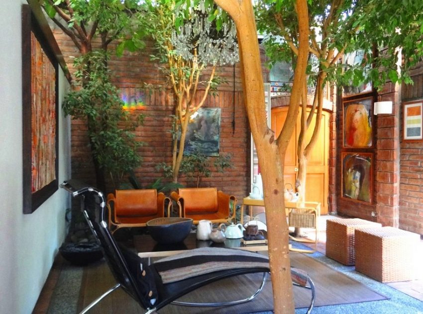 Interior Design Medium size Outdoor Relaxing Spot With Black Leather Metal Reclining Chairs Beneath Maple Tree Before Artistic Paintings