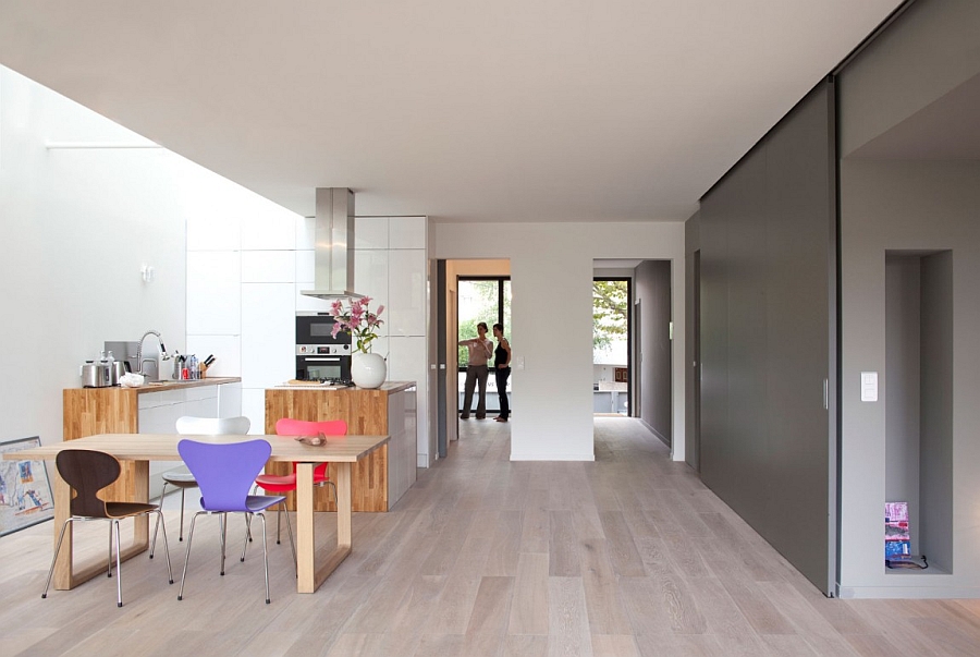 Spacious Room Design With Rustic Wooden Table And Purple Red Chairs Beneath Bright Skylight Interior Design