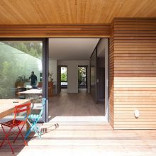 Interior Design Mesmerizing Black Relaxing Chair Aside Floor Lamp Upon Wooden Floor Below Framed Large Window Design Amazing Eco Friendly Prefabricated Modular House in Paris