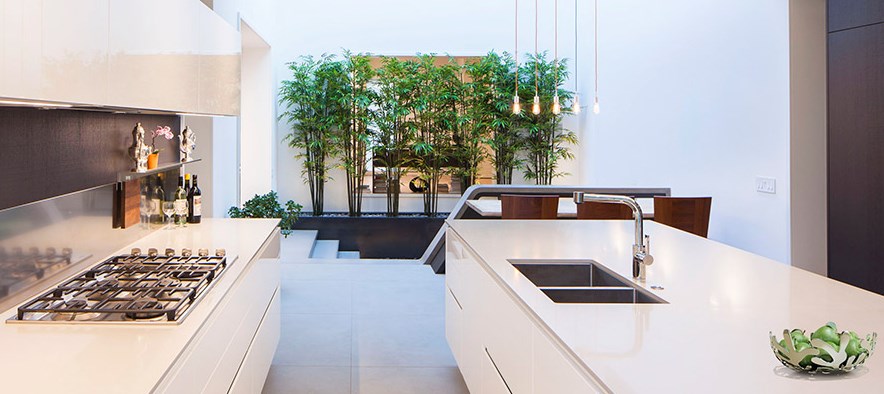 White Range Kitchen Cabinet With Sophisticated Cook Top Aside Indoor Greenery With Brown Backsplash Interior Design