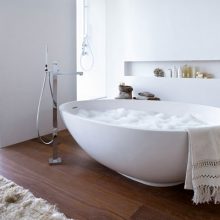 Bathroom Wooden Floor White Egg Shaped Bathtub Glass Windows wooden-floor-white-bathtub-steel-faucet-white-wall1-915x814