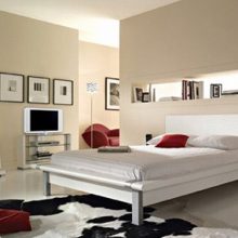 Bedroom Futuristic Designed Bed White Bed Cover Big Mirror Red Pillows Modern-bed-Brown-bed-sheet-Brown-rugs-Natural-wood-colored-drawer