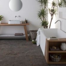 Bathroom Stone Floor White Wall White Bathtub grey-marble-sink-grey-wall-small-round-mirror-wooden-table