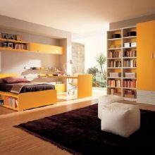 Teen Room Bedroom Black Rug Yellow Cabinets Yellow Bookcase Glass Window Bedroom-White-Rug-Wood-Flooring-Unique-Lamp-Bookcase